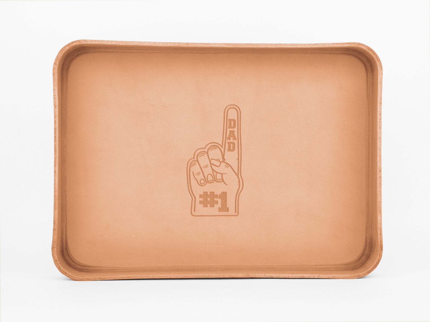 A rectangular tan leather tray with raised edges, featuring an engraved image of a hand holding up one finger, labeled DAD #1.