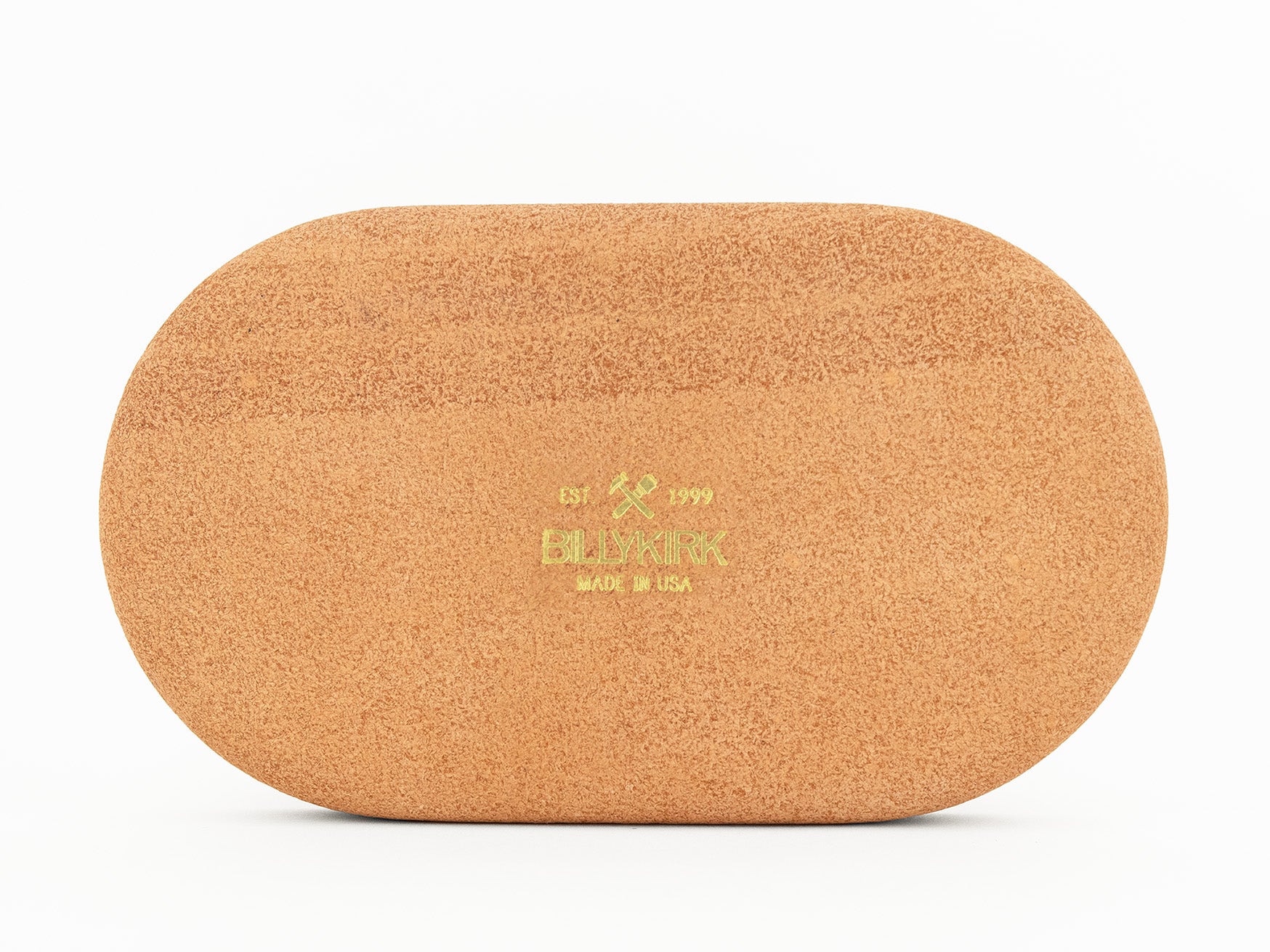 The back of an oval-shaped, natural colored leather tray with Billykirk MADE IN USA and a crossed hammer and maul logo printed in gold foil on the back, placed against a white background.