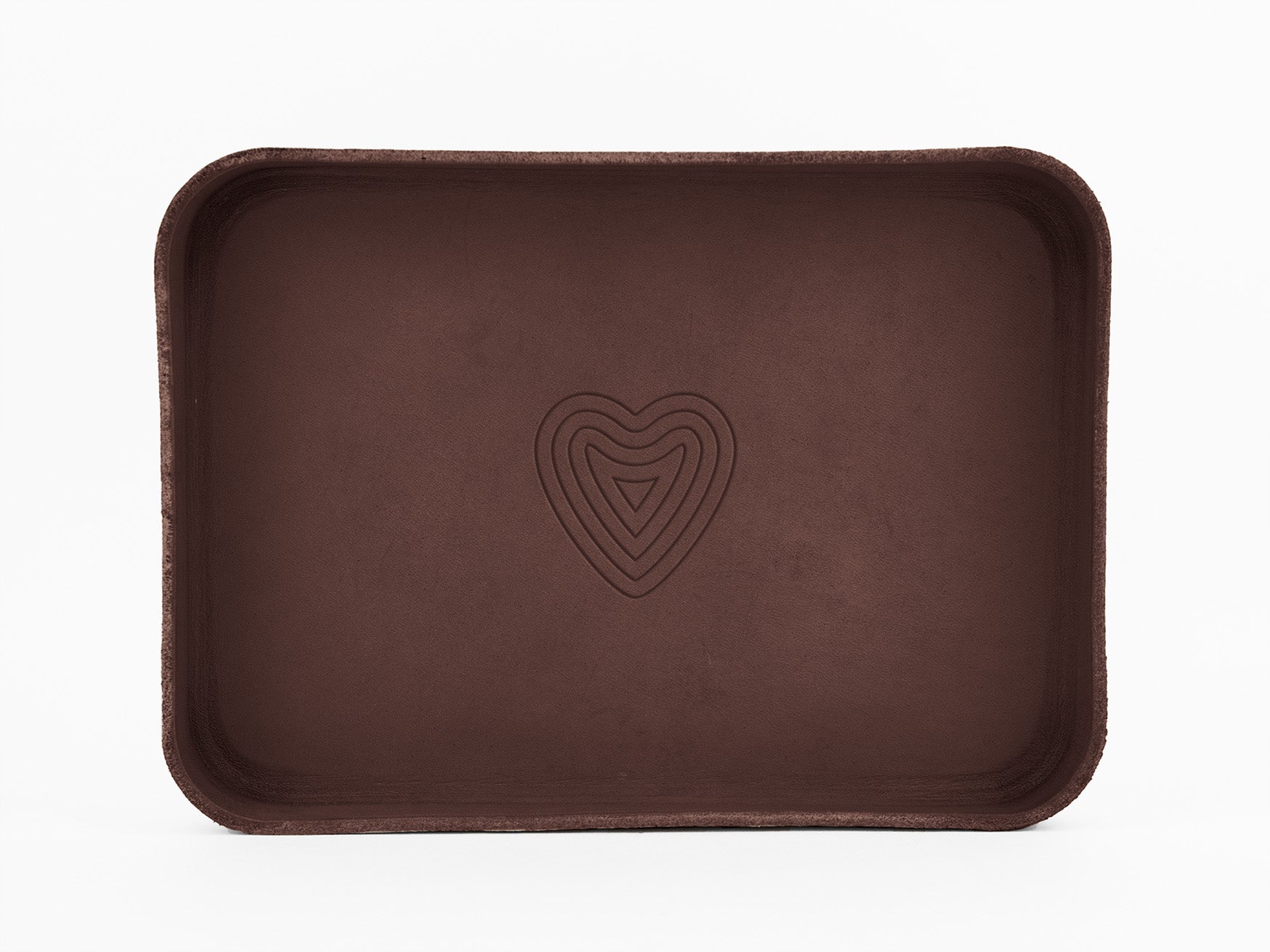 A rectangular, brown tray with rounded corners and a layered heart-shaped design embossed in the center, set against a plain white background.
