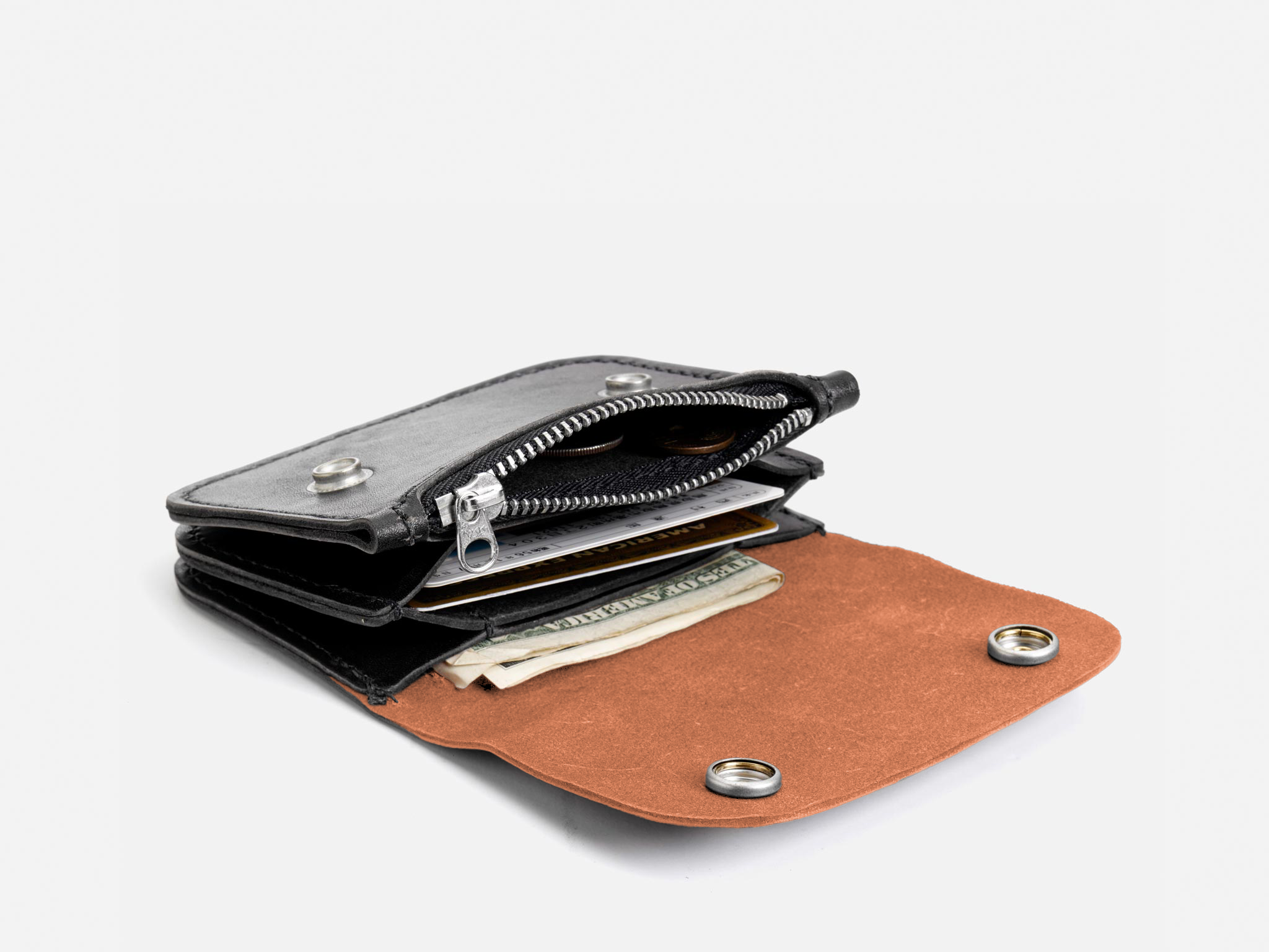 A brown and black leather wallet with an open zipper and snap buttons, showing cash and cards inside, on a white background.
