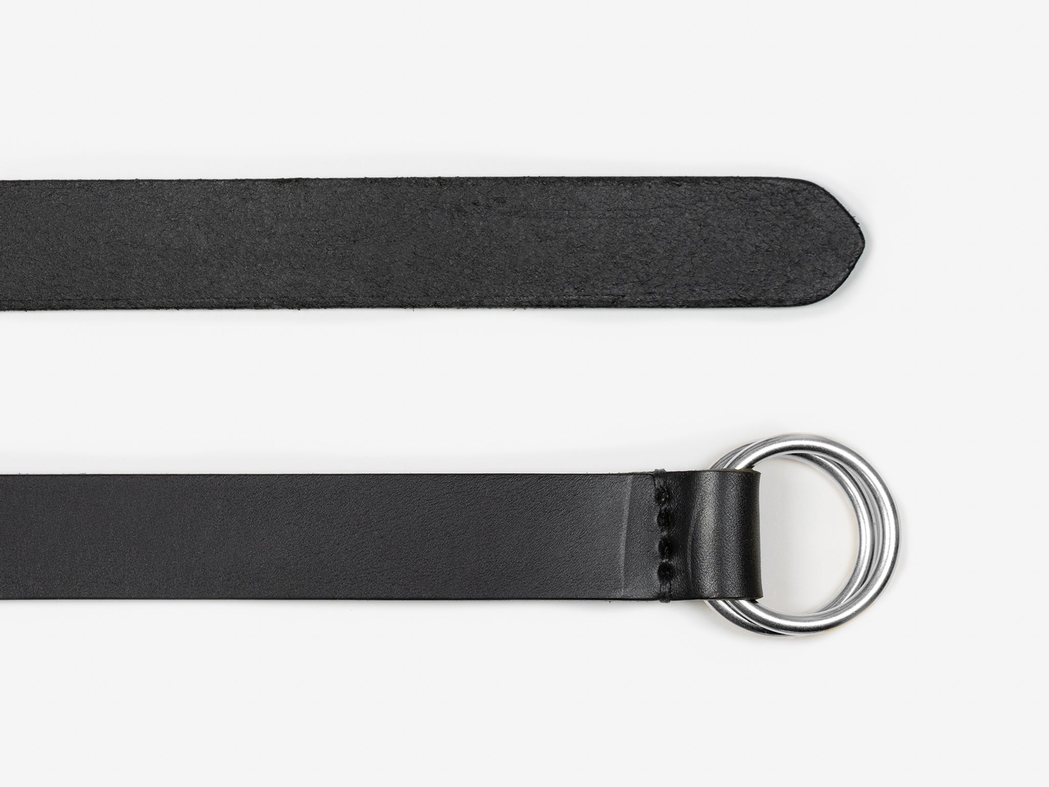 A black leather belt with a silver double D-ring buckle, shown laid flat on a white background. One end is pointed, and the other end is secured around the rings.