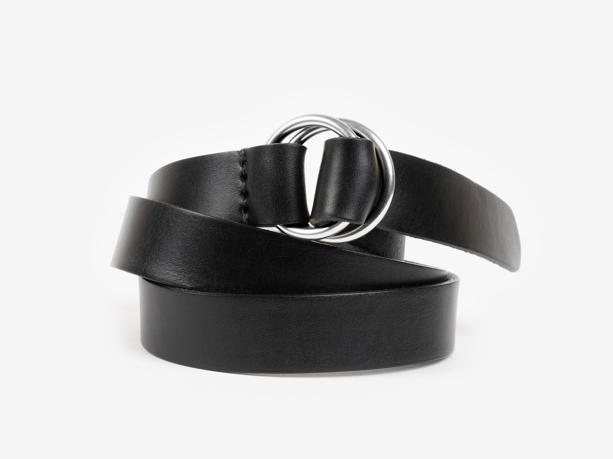 A black leather belt with a shiny silver double-ring buckle, coiled neatly against a plain white background.