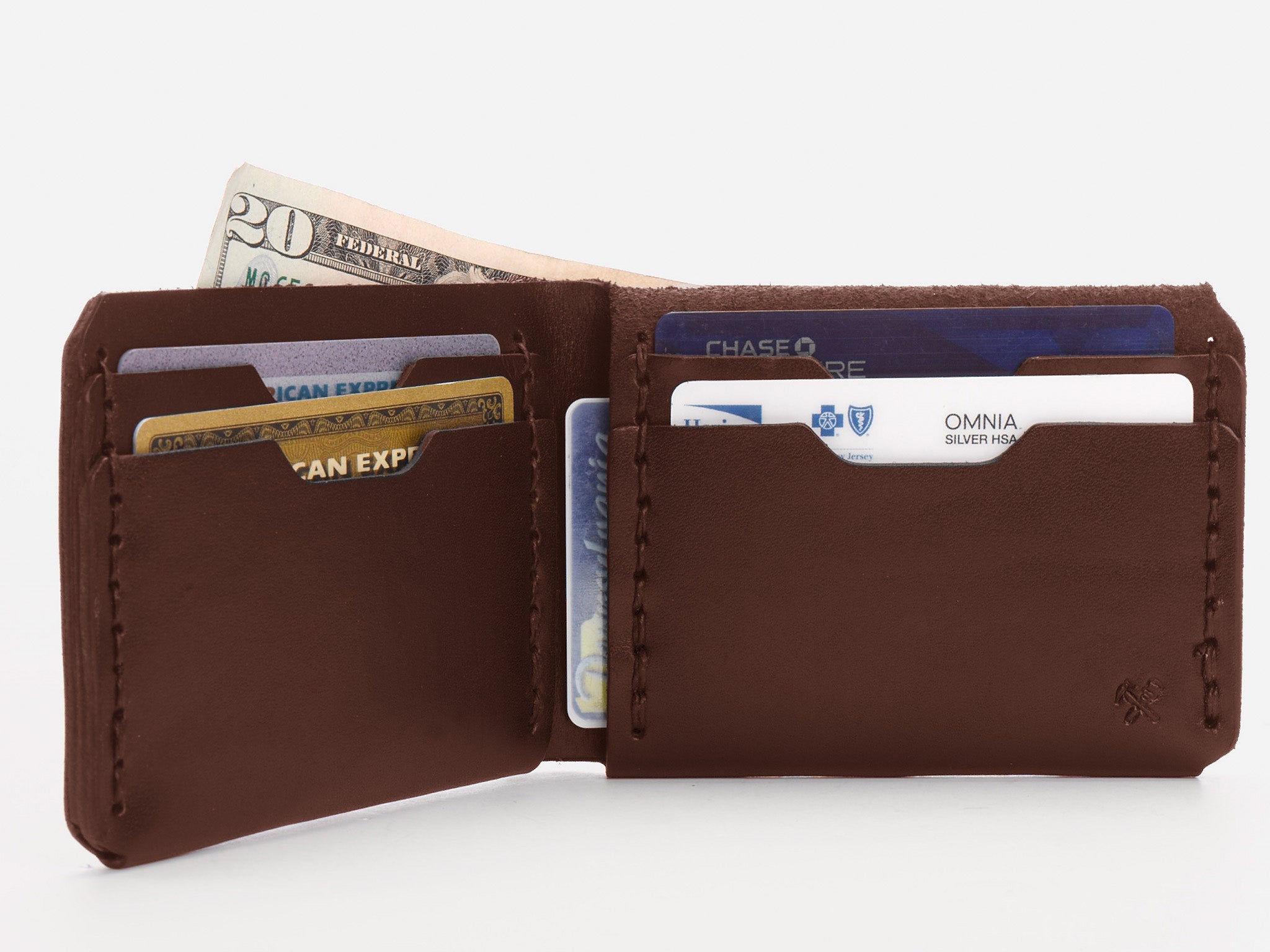 A brown leather wallet open to show several credit cards and a twenty-dollar bill inside its slots, against a white background.