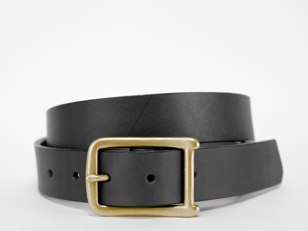 A black leather belt with a gold rectangular buckle is coiled on a white background.