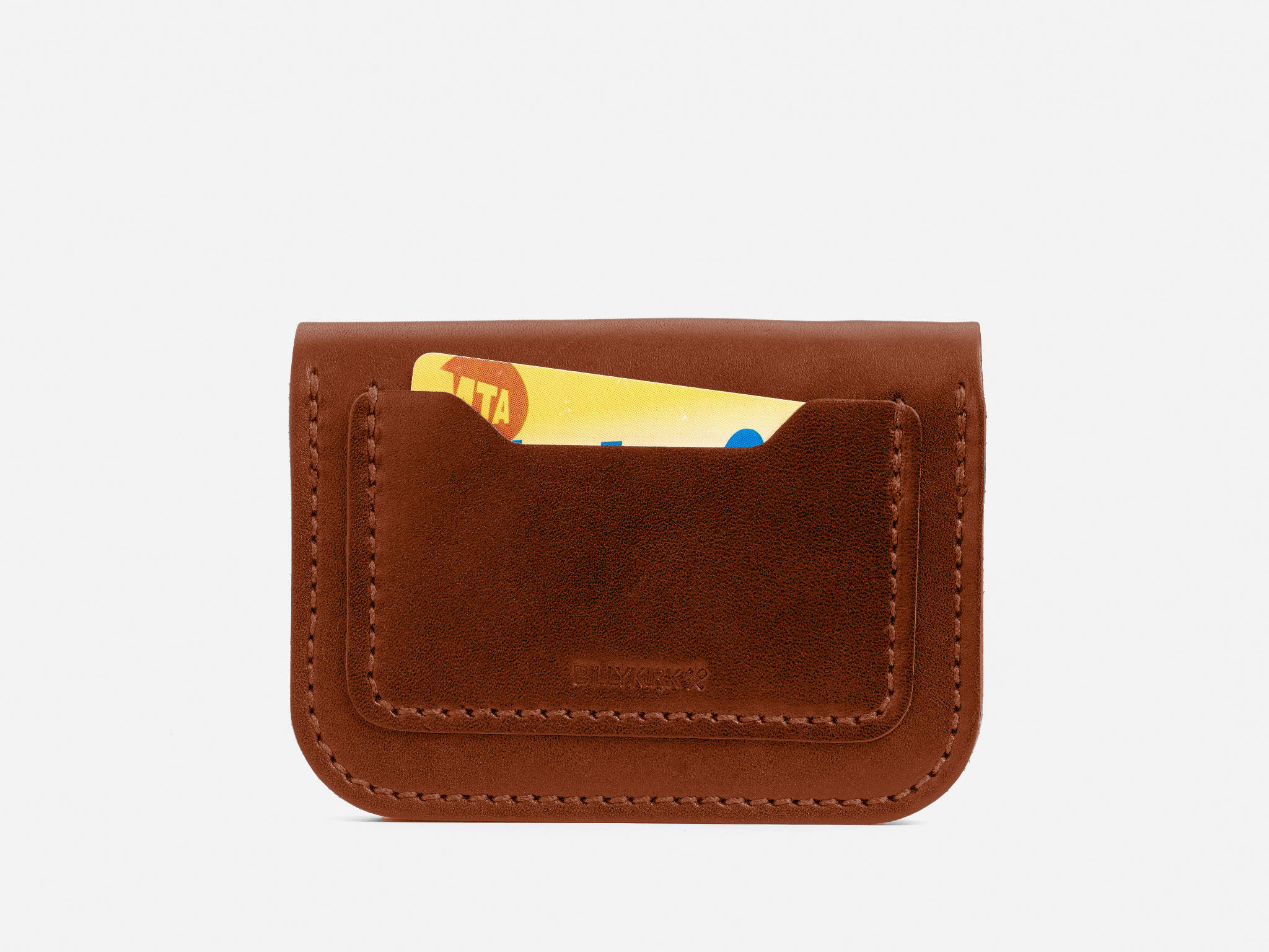 A brown leather cardholder with clean stitching, holding a partially visible yellow and red card in its front pocket, set against a plain white background.