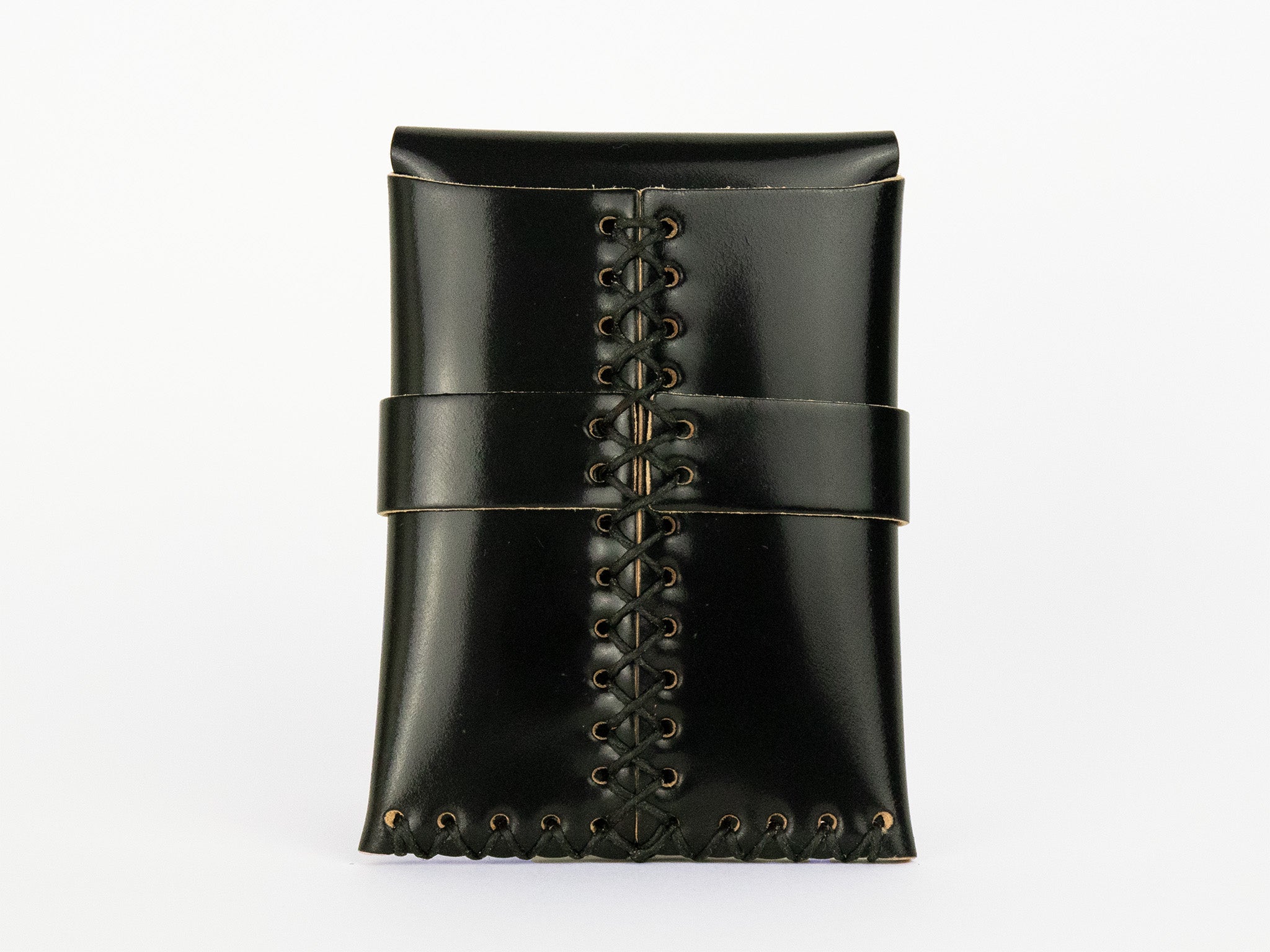 A black leather pouch with decorative stitching down the center and around the edges, closed with a matching leather strap, standing upright against a plain white background.