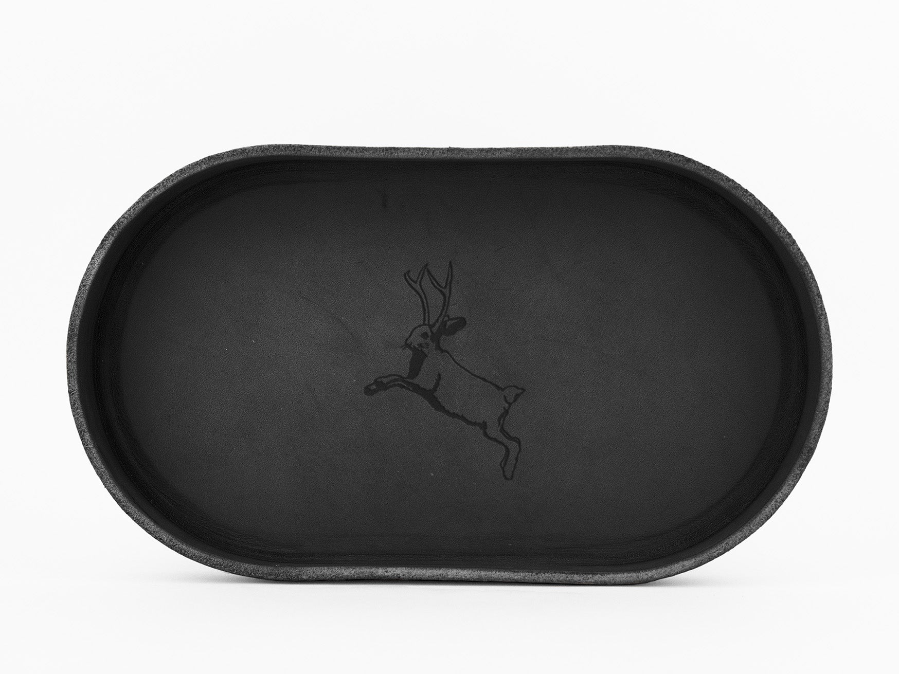 A black oval tray with a simple line drawing of a leaping deer with antlers in the center, set against a plain white background.