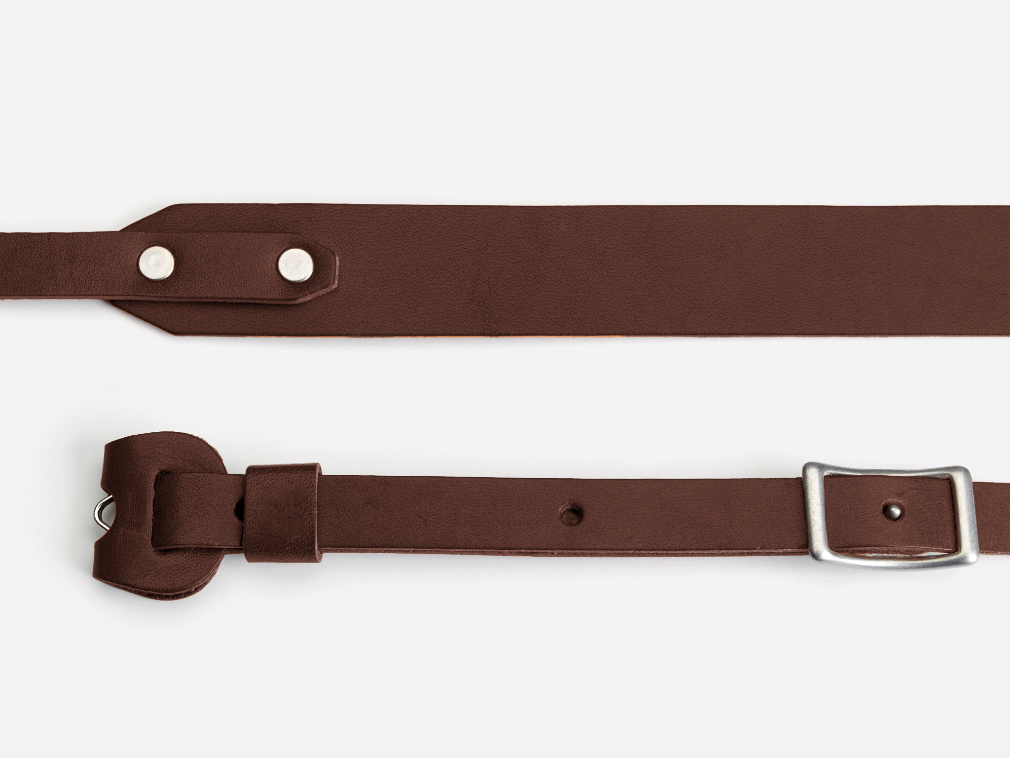 Two brown leather belt straps are shown on a white background; one has a silver buckle and the other has two silver rivets.
