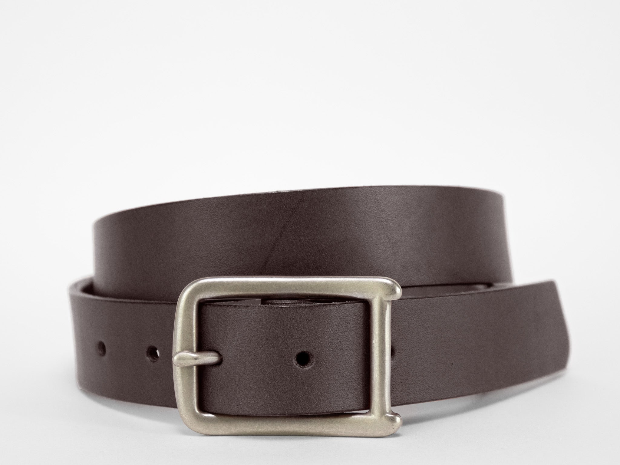 A coiled dark brown leather belt with a silver rectangular buckle is displayed on a plain white background.