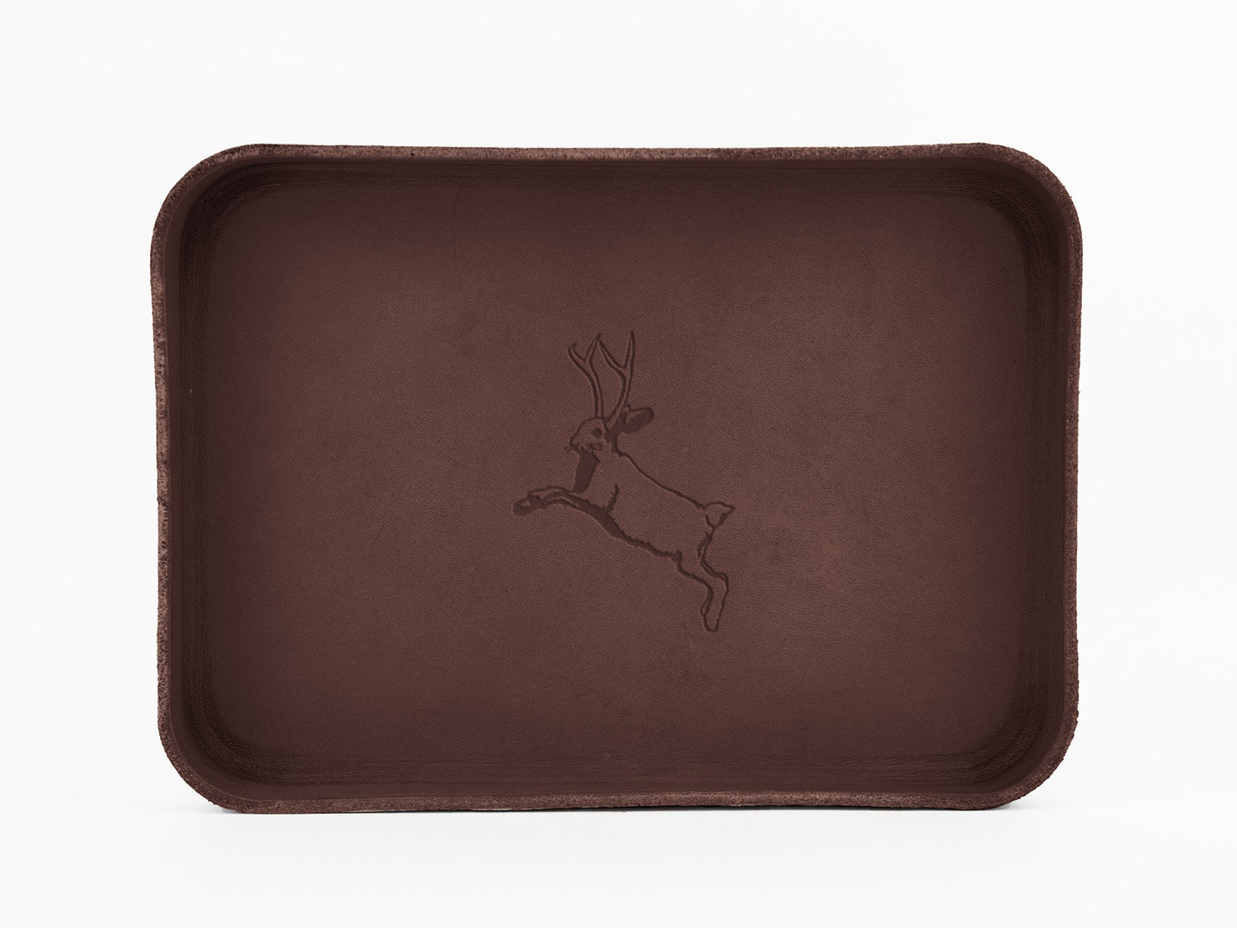 A rectangular brown tray with rounded corners, featuring an engraved illustration of a leaping jackalope in the center.