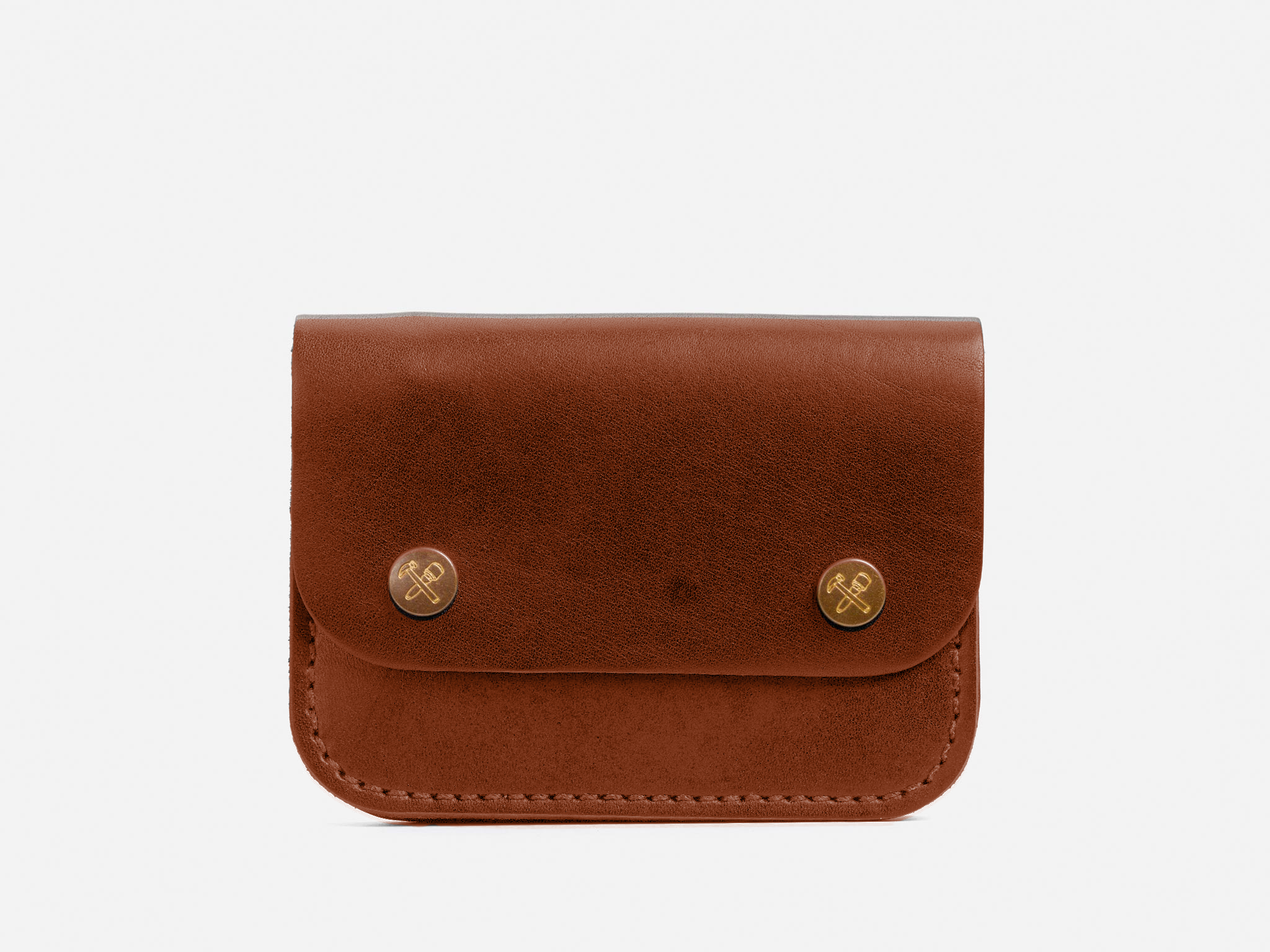 A small brown leather pouch with a flap secured by two gold-colored snap buttons, displayed against a plain white background.