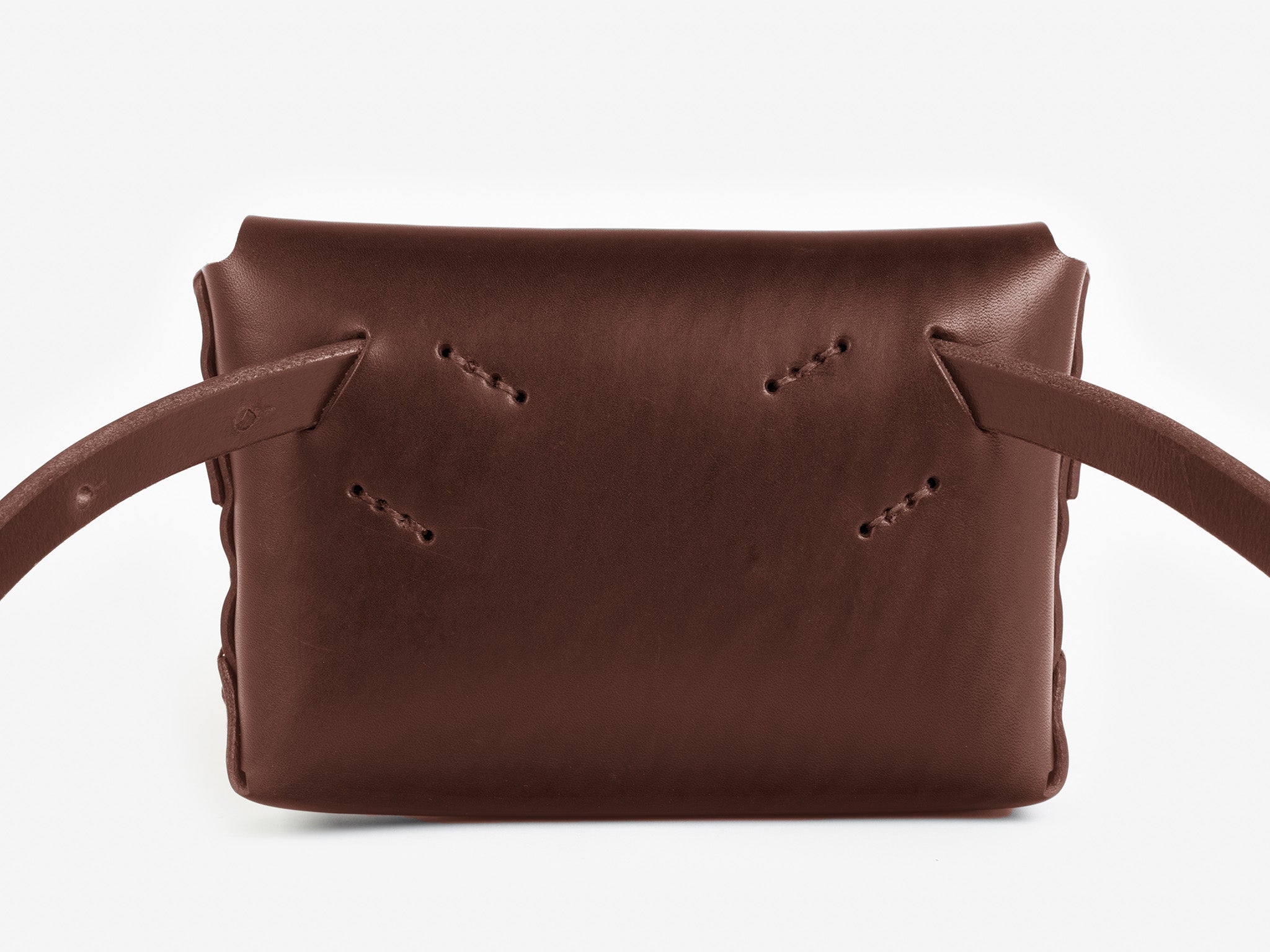 Back view of a hickory leather belt crossbody bag with a smooth finish, featuring  hand-stitching details, displayed against a white background.