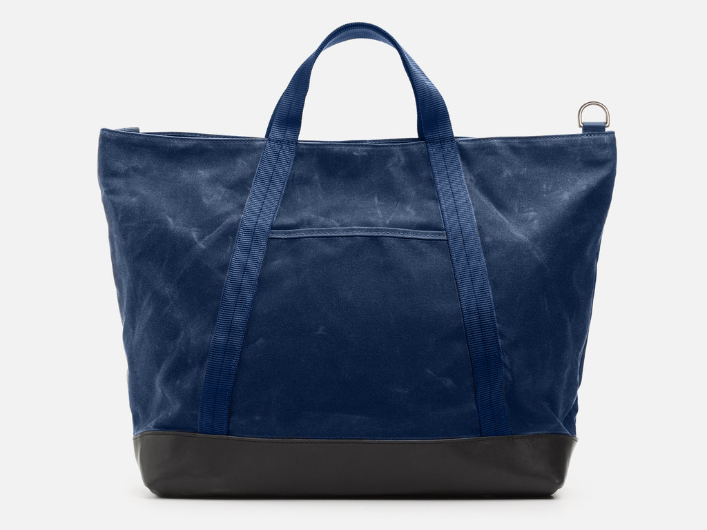 Blue tote bag with black base on a white background