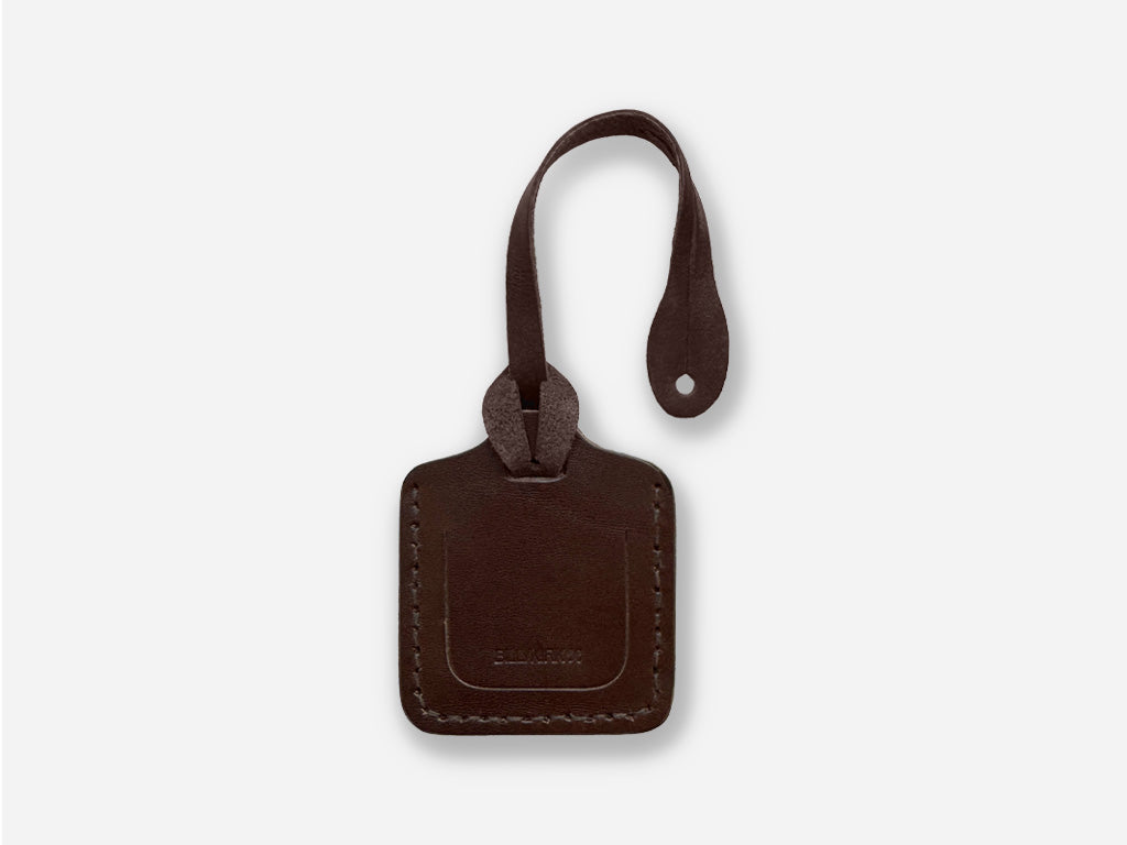 Brown leather luggage tag on a white background