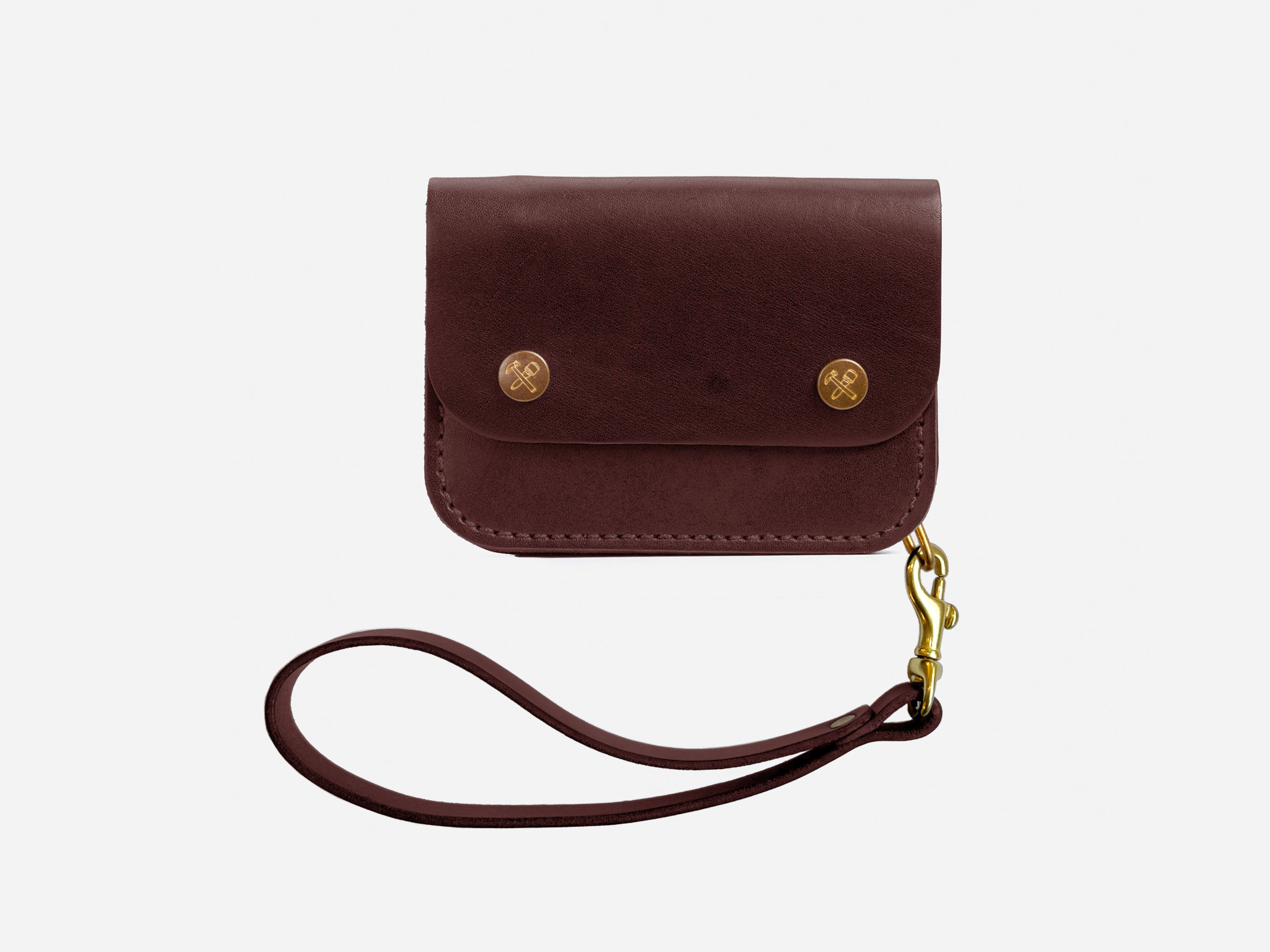A small brown leather wallet with two gold snap buttons and an attached wrist strap, displayed against a plain white background.
