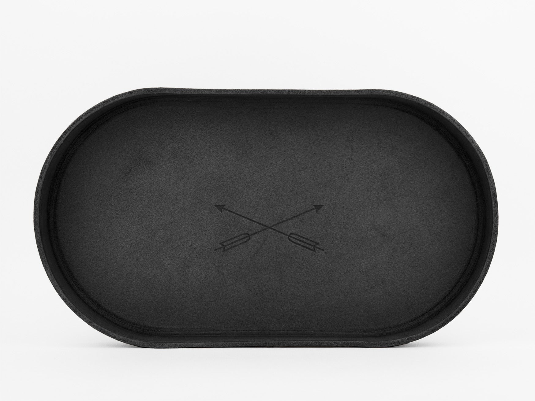 A black, oval-shaped tray with a minimalist design featuring two crossed arrows in the center, set against a plain white background.