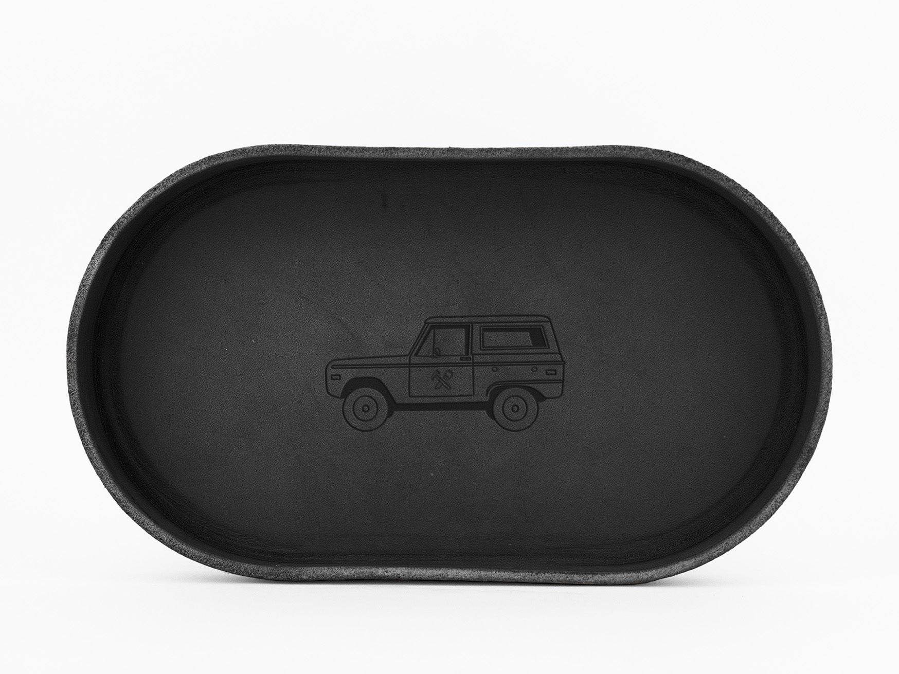 A black, oval-shaped tray with a simple, engraved outline of an SUV or off-road vehicle in the center, displayed against a white background.