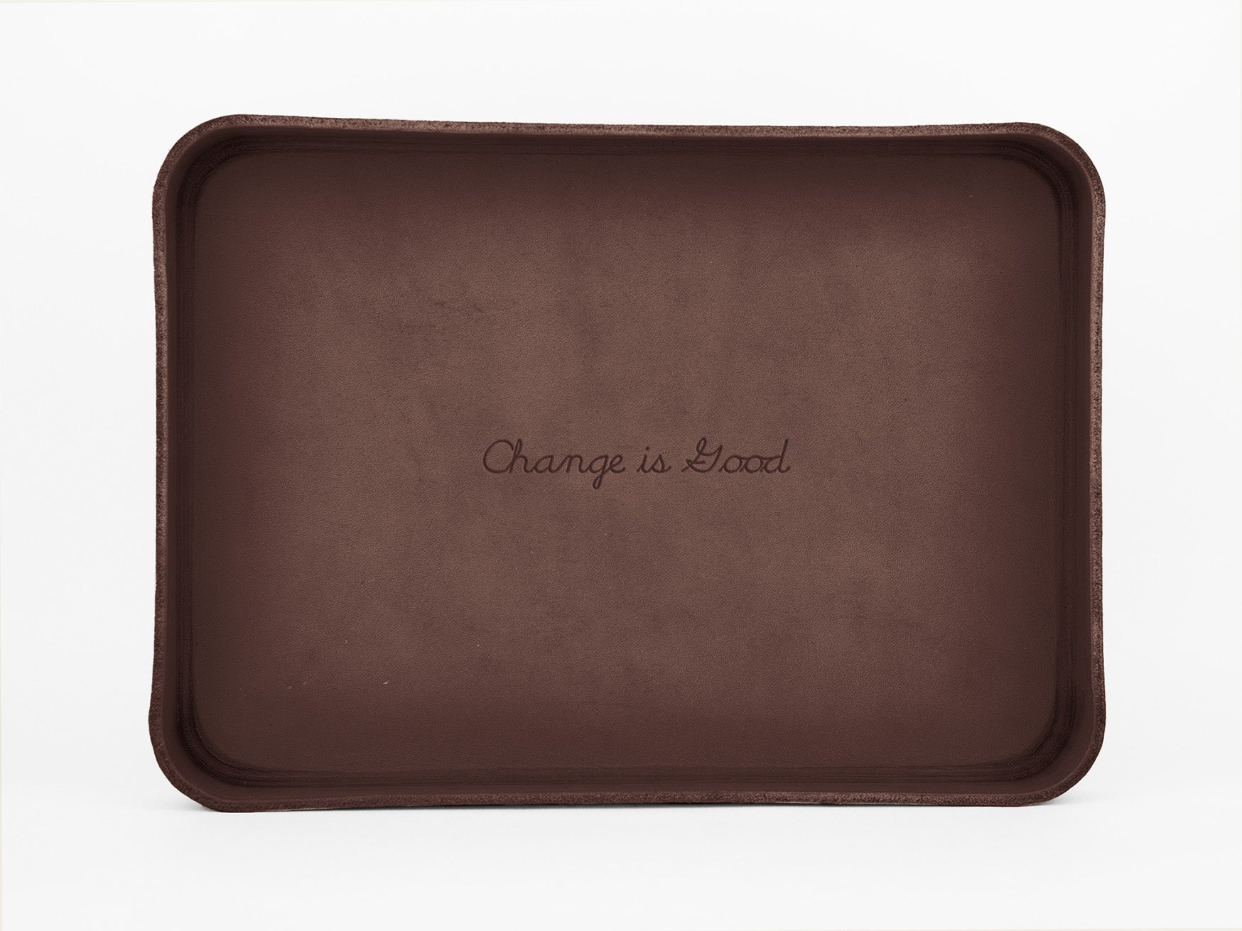 A rectangular brown tray with the words Change is Good written in cursive in the center against a plain white background.