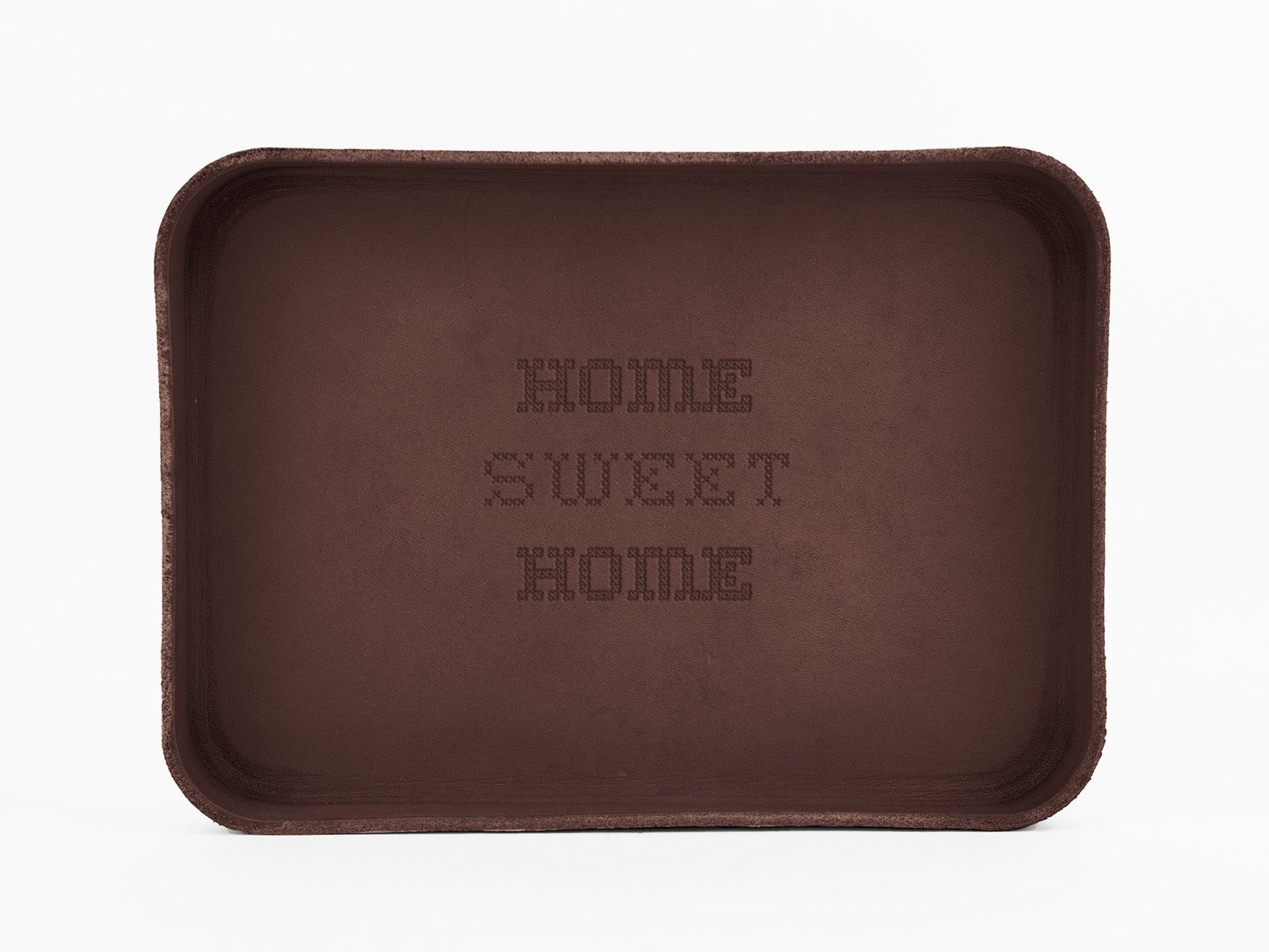 A rectangular brown tray with the words HOME SWEET HOME embossed in the center, displayed against a plain white background.