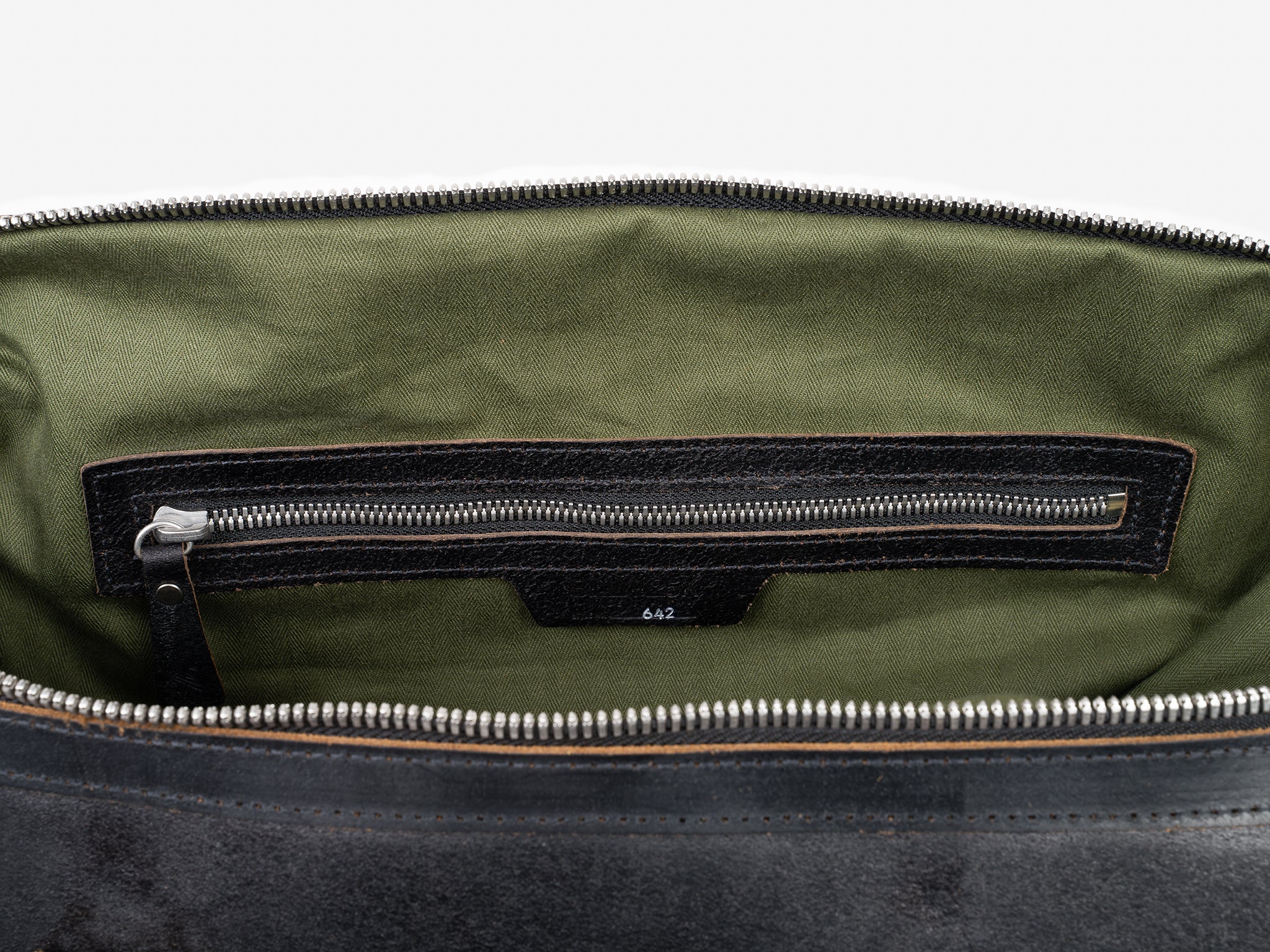 Open view of a zippered bag with an olive green fabric lining and an interior zippered pocket. The zipper and trim are black, and the number 642 is printed below the pocket.