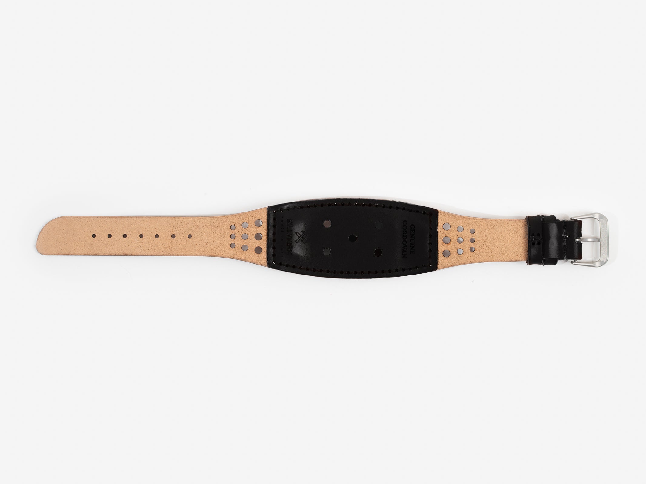The back of the watch strap with natural and black cordovan leather with holes, a silver buckle, and BILLYKIRK embossed on it.