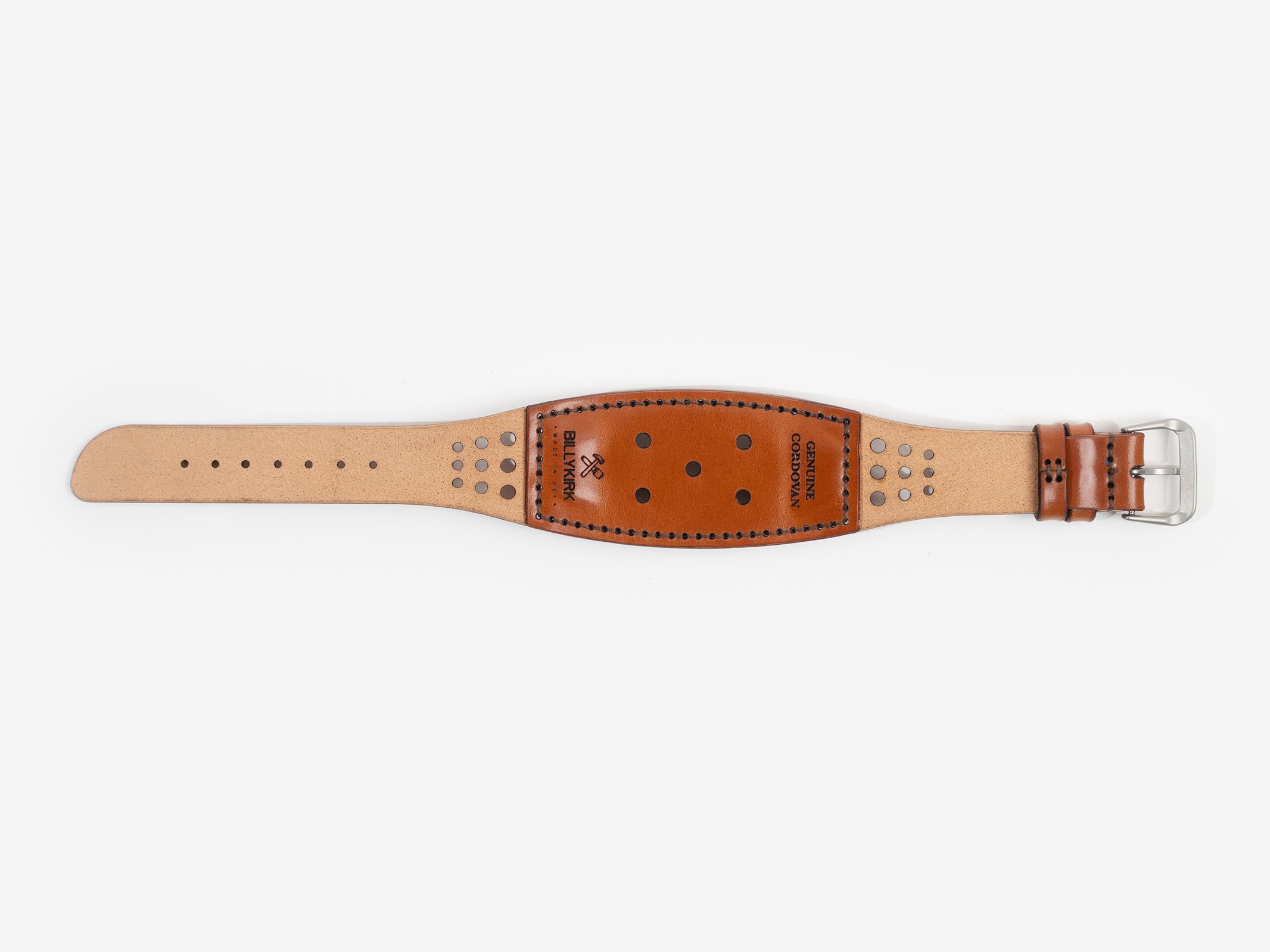 The back of the watch strap with natural and tan cordovan leather with holes, a silver buckle, and BILLYKIRK embossed on it.