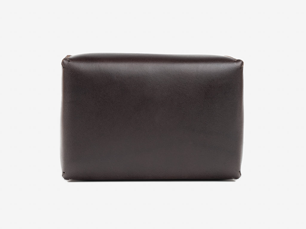Top view of a dark brown leather box lid showing where the debossed personalization gets stamped. Set against a white background.