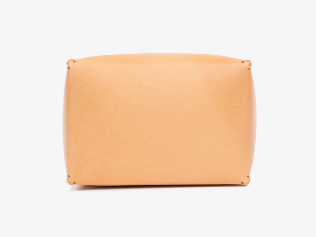 Top view of a natural leather box lid showing where the debossed personalization gets stamped. Set against a white background.