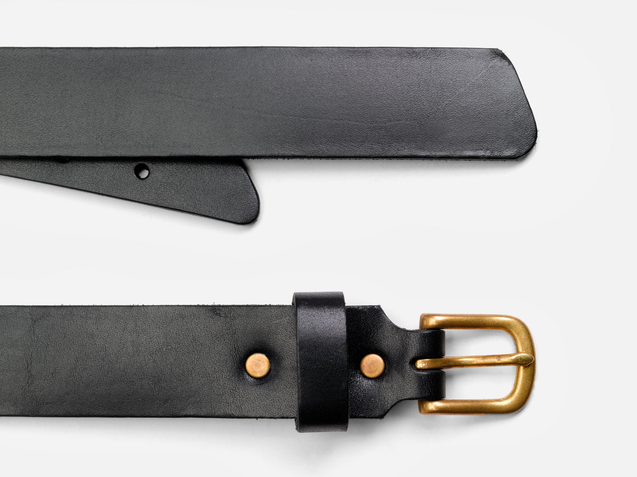 A black leather belt with a gold metal buckle and two gold rivets, shown laid flat on a white background.