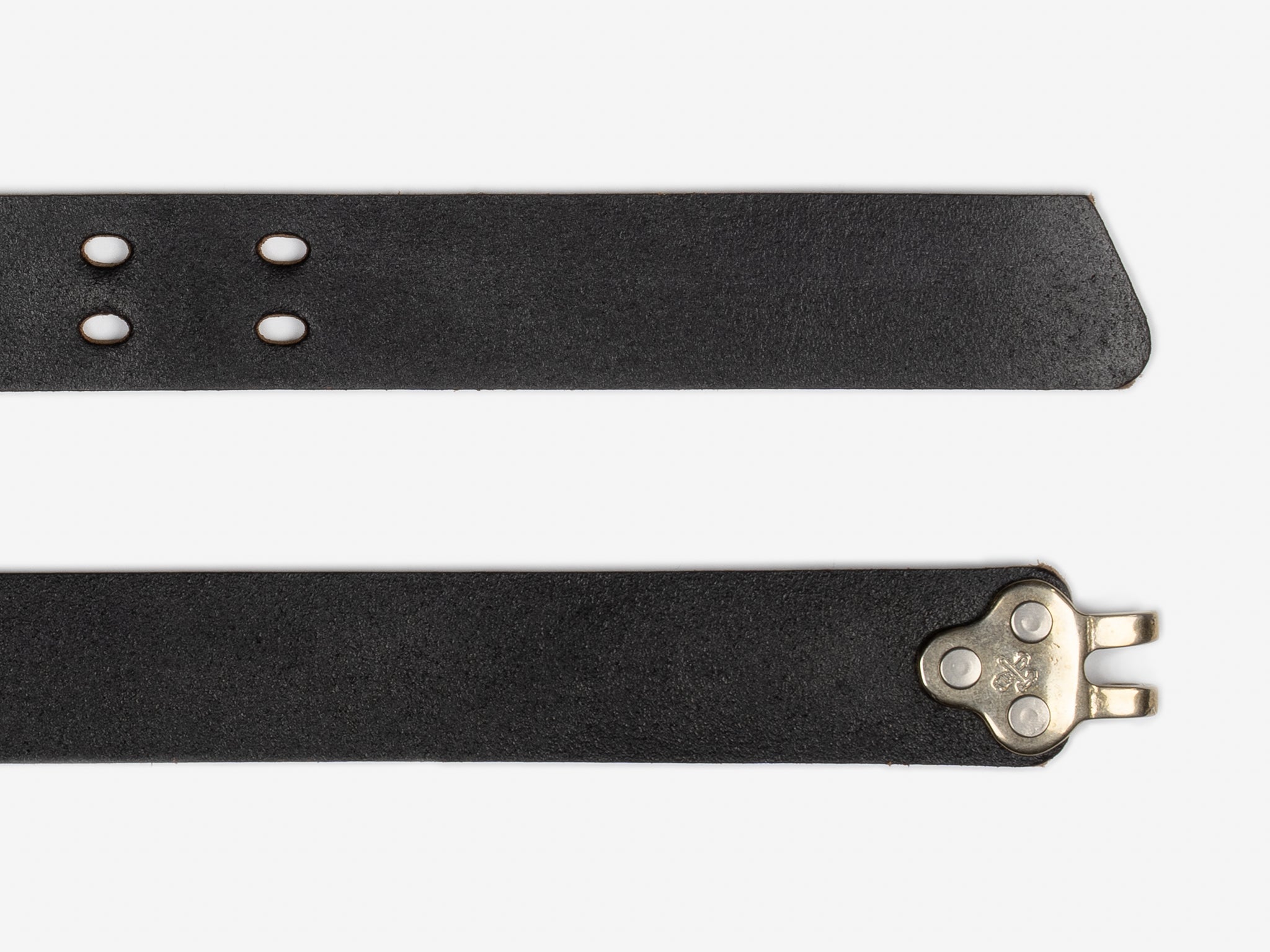 Two strips of black leather, one with punched holes and a pointed end, the other with a silver metal clasp at the end, set against a plain white background.