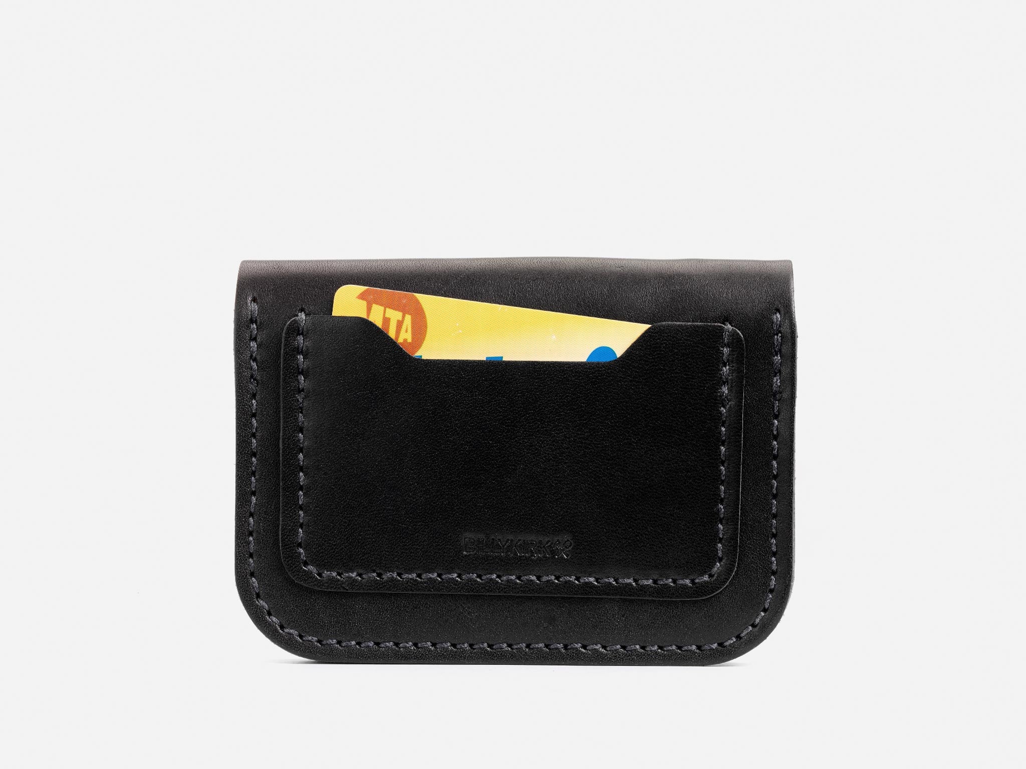 A black leather card holder with visible stitching, holding a partially visible card with yellow and red markings on a plain white background.