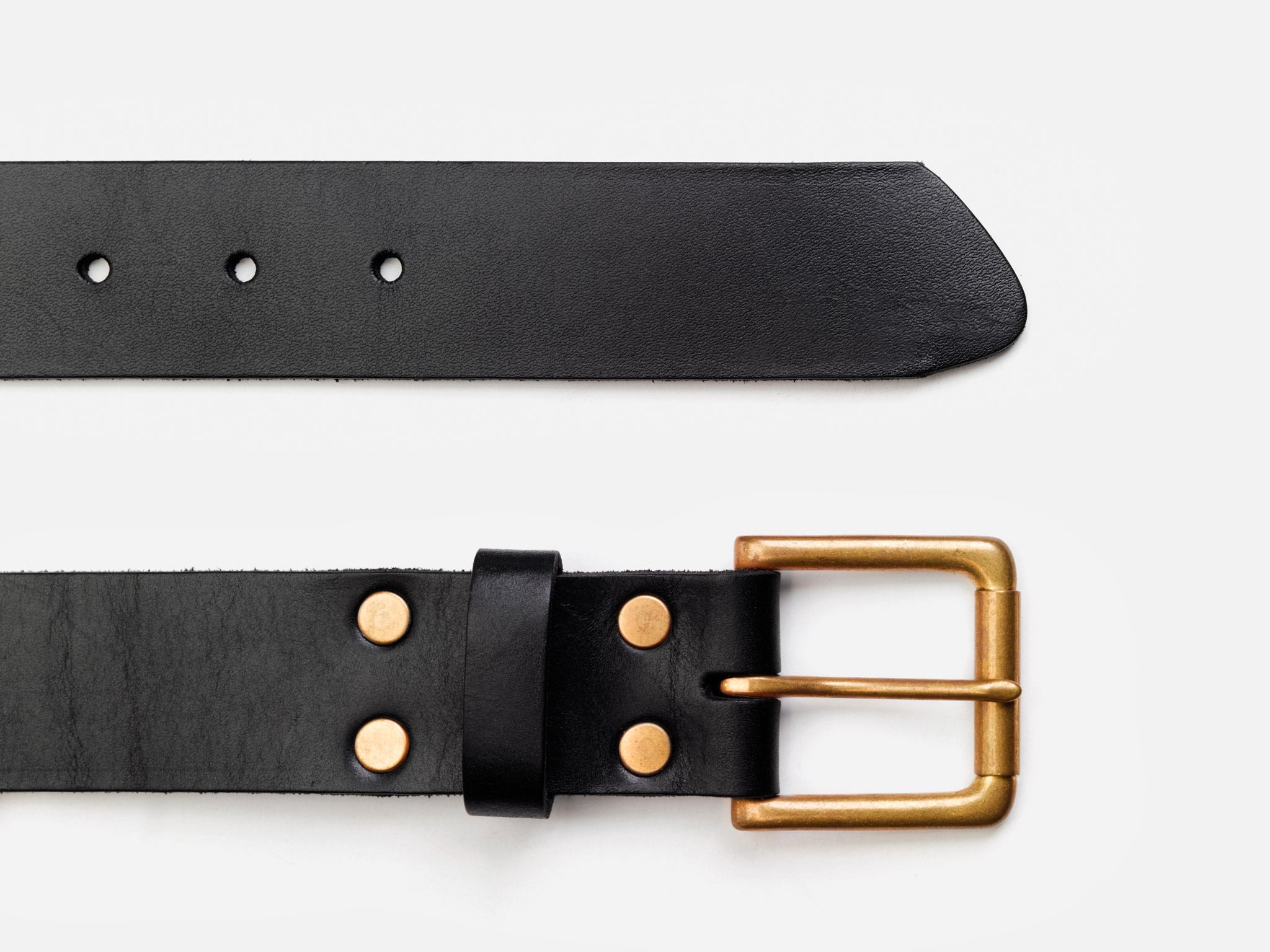 A black leather belt with a gold rectangular buckle and round gold studs, shown laid flat with both the buckle end and the pointed end visible on a white background.
