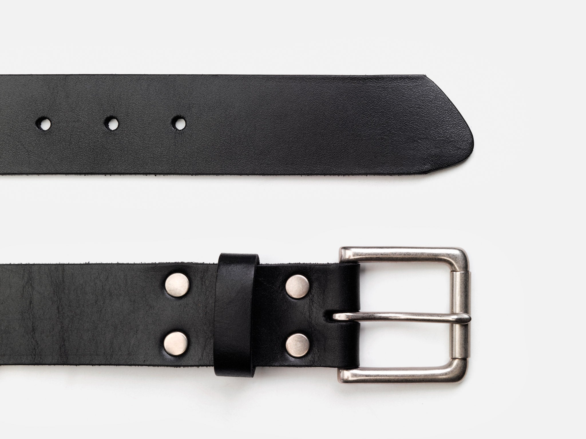 A black leather belt with a silver buckle and metal rivets, shown laid flat on a white background. The belt has several holes for size adjustment.