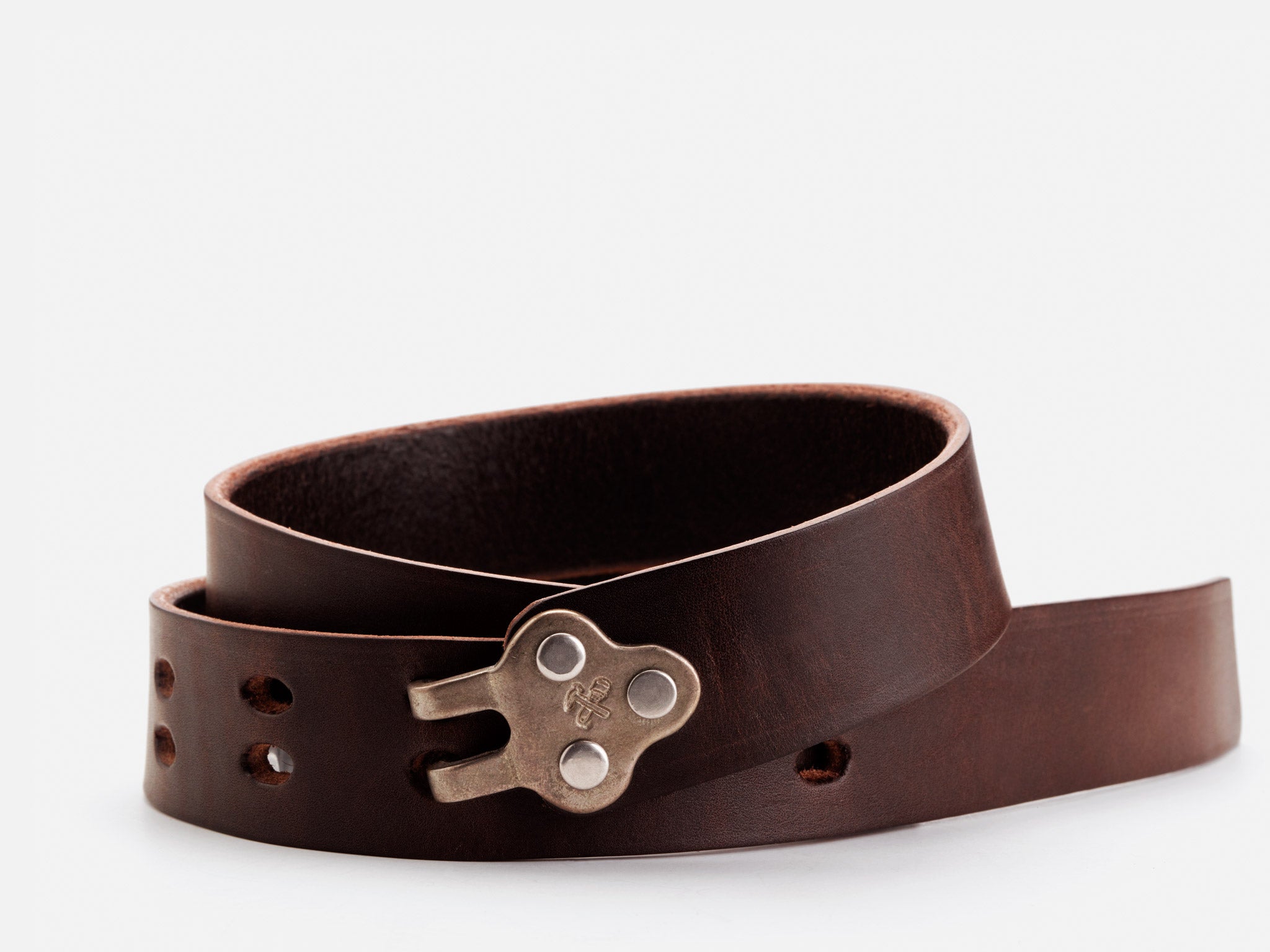 A dark brown leather belt with a unique metal buckle shaped like a key, displayed coiled on a white background.