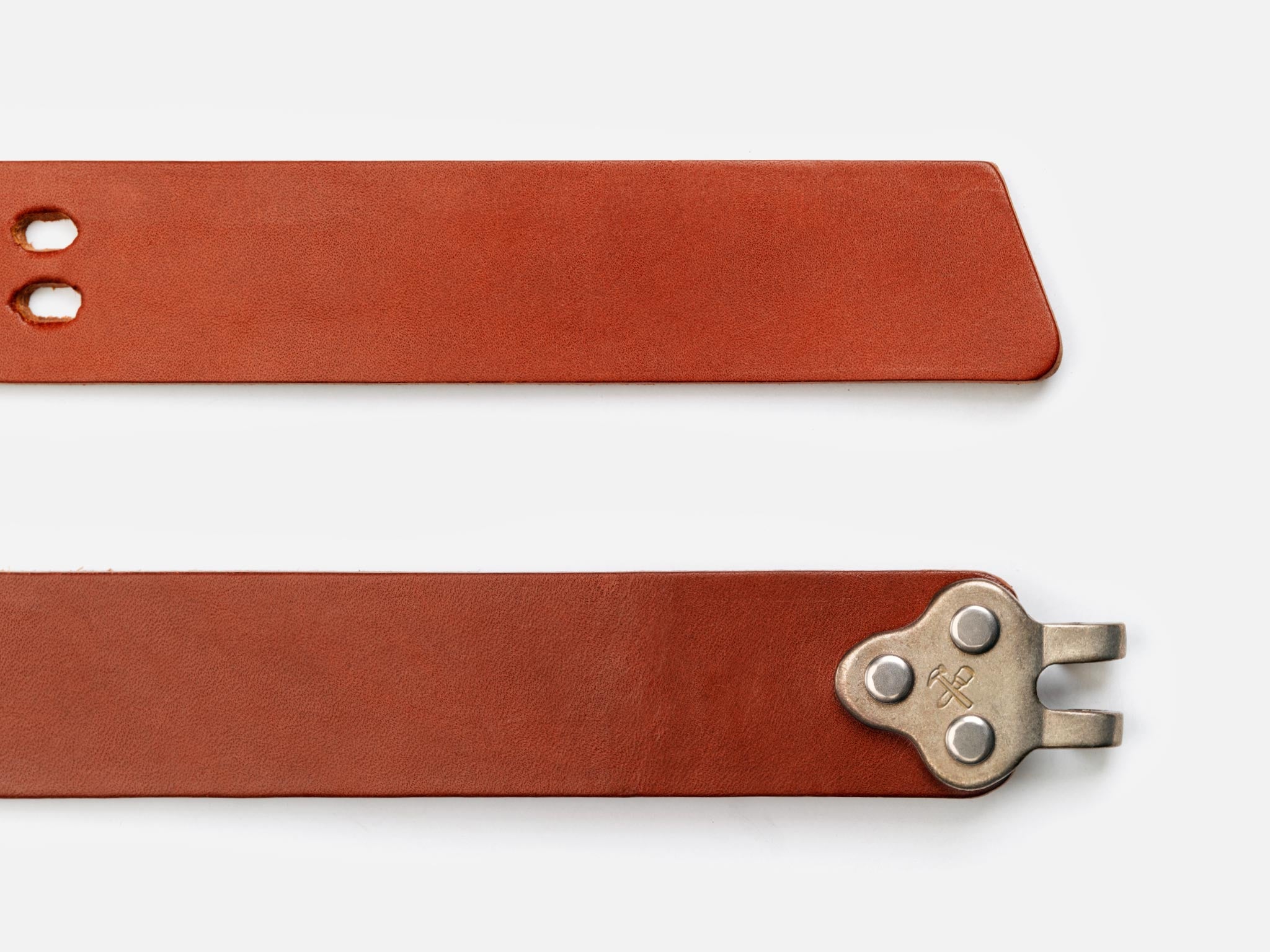 Two sections of a brown leather belt are shown. One end has two holes, and the other has a silver metal buckle with a unique forked design. The background is white.